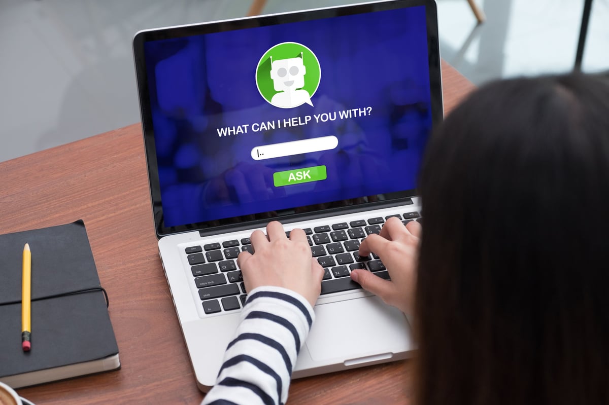 Person asking a question to an AI chat assistant on a laptop screen