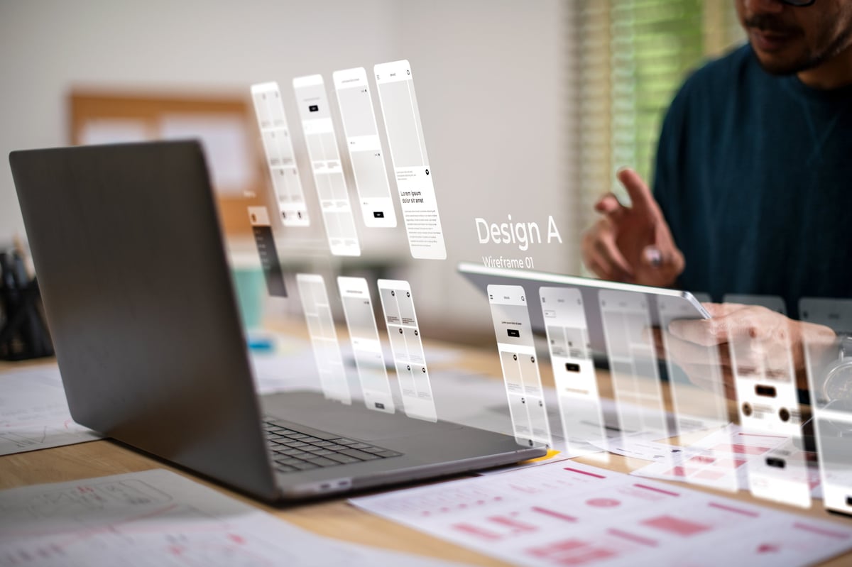 Designer working on a website prototype and mobile app interface