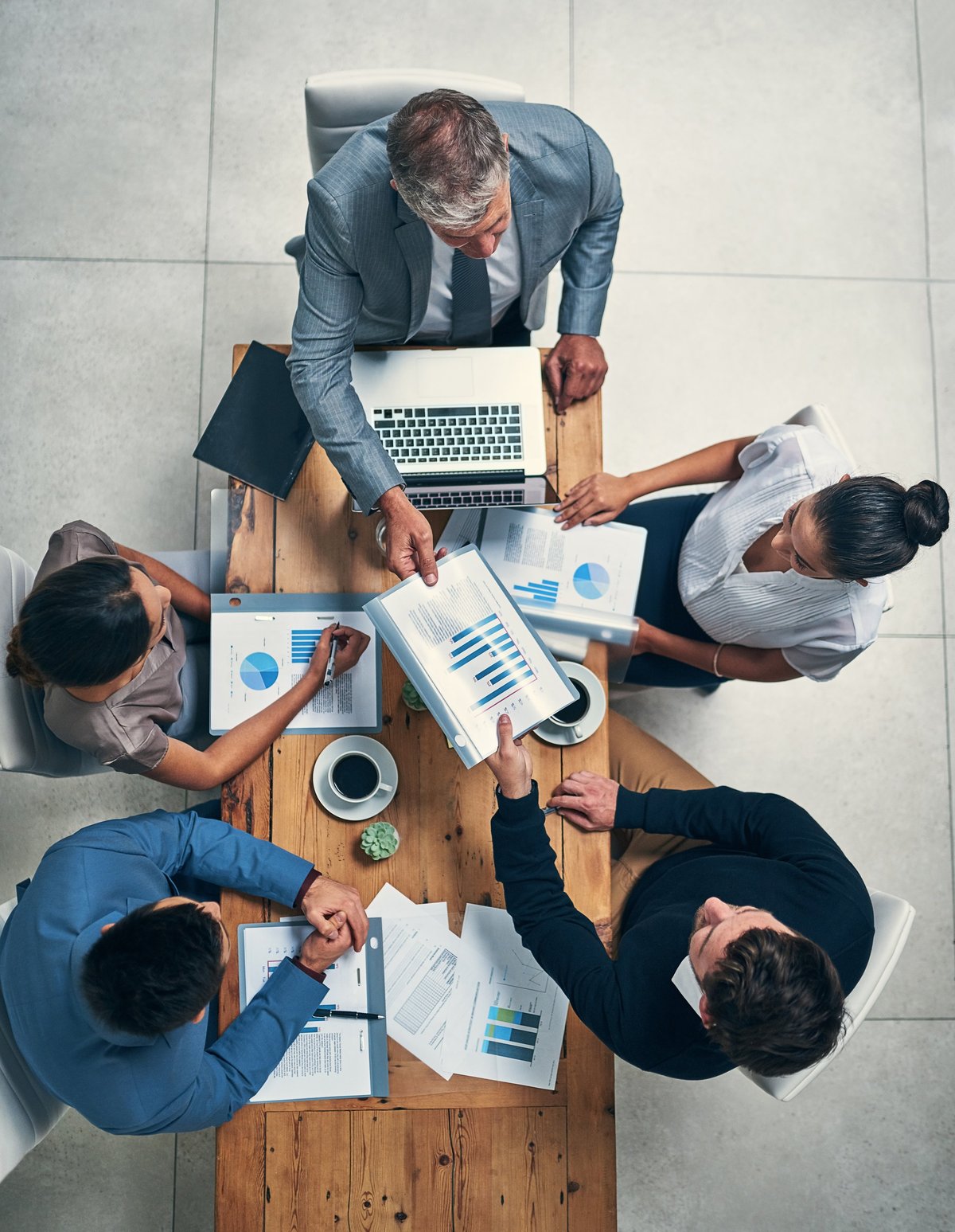 Business meeting reviewing growth plans around a table